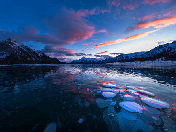 istock ice bubble and sunrise at Abraham Lake 1204042623