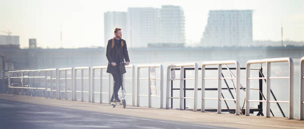 istock Young businessman on e scooter in the city 1204043472