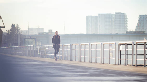 istock Young businessman on e scooter in the city 1204043492