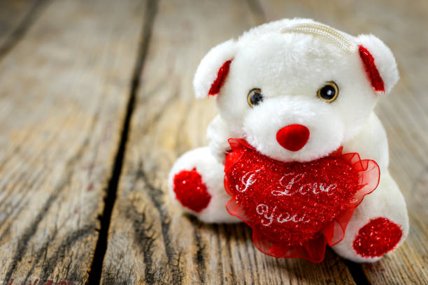 istock Teddy bear is sitting on a wooden table 1204043931