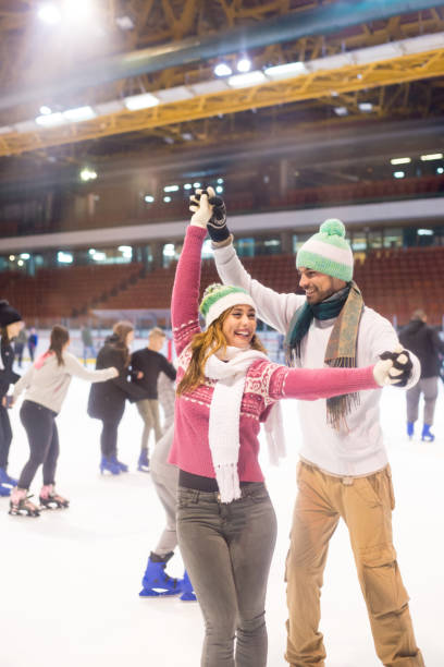 istock Young couple ice skating in winter 1204044828