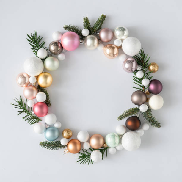 Natural Christmas wreath with green pine tree branches and ball decoration.