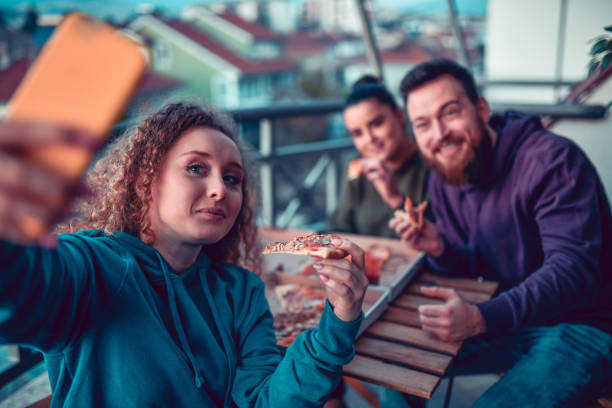 istock Friends Taking Selfie While Enjoying Good Pizza 1204046455