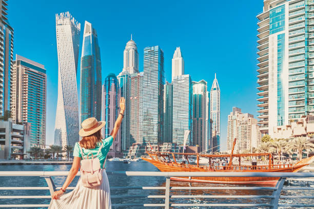 alegre chica viajera asiática caminando en un paseo marítimo en el distrito de dubai marina. destinos de viaje y estilo de vida turístico en eau - dubai fotografías e imágenes de stock