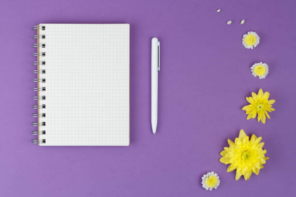 istock Top view open notebook, with pen and flowers. 1204048247