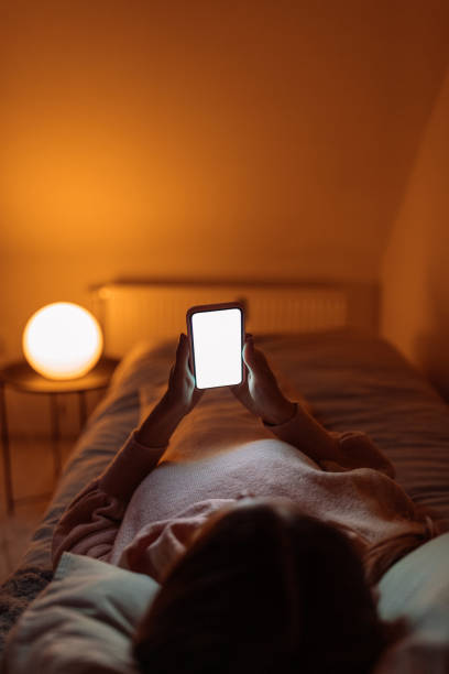 istock Chilling in bed with her phone 1204048557