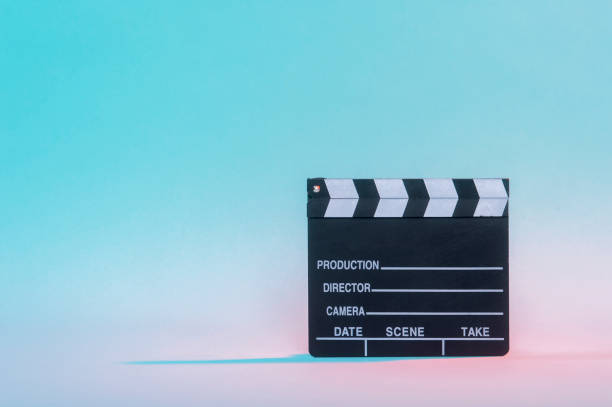 istock Movie clapper on neon background, cinema concept. 1204051635