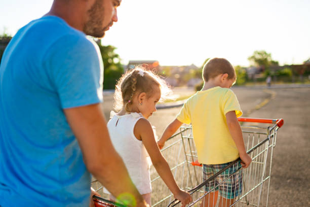 istock Single father at grocery shopping with children 1204054638