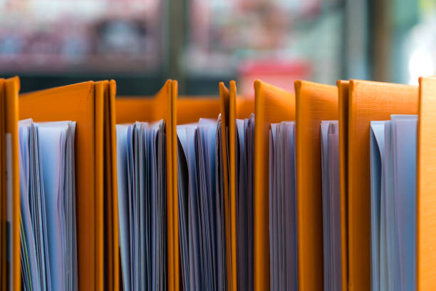 istock Documents Binder Paper, Orange Files folder on office desk, Annual Report document for Business papers financial market in offices, lawyer research achieves. Concept work hard or a lot information 1204055605