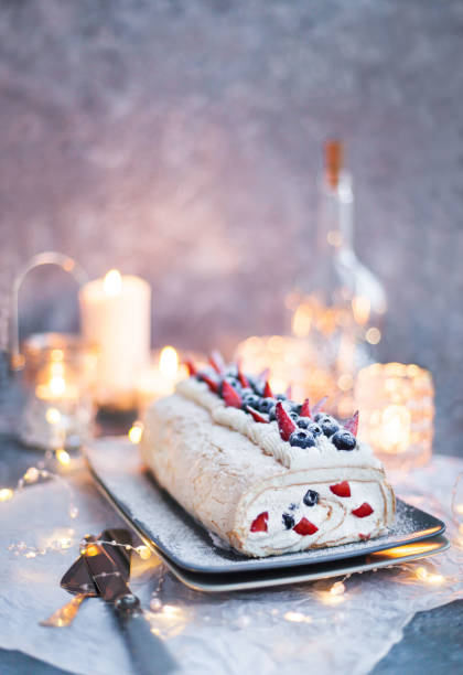 istock Meringue roll cake with cream and fresh berries 1204057011