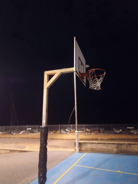 istock Basketball hoop at night by beach Brighton UK 1204060501