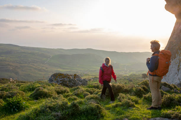 istock Hiking couple relax in meadow, below rock bluff 1204060540