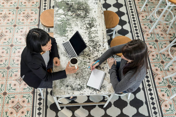 istock Two Women Business Meeting Hip Cafe 1204064472