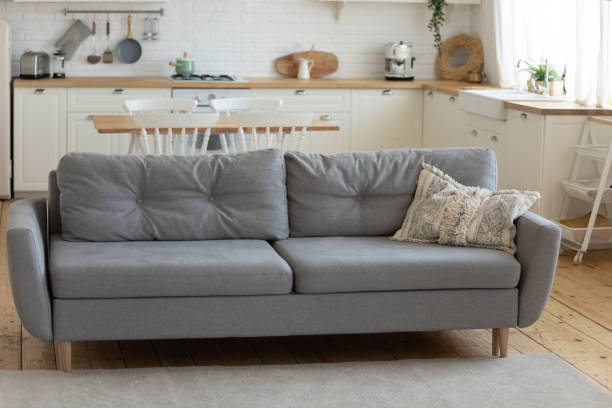 istock Grey comfy sofa in cozy countryside house 1204066297