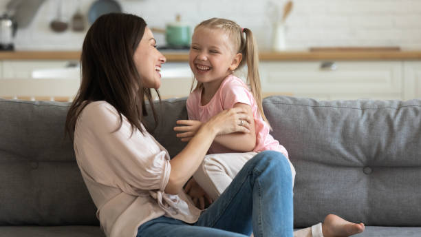 istock Overjoyed young mom playing with little girl 1204066325