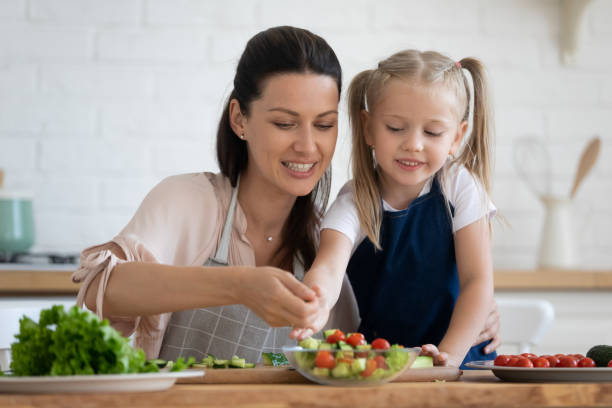 istock Young mom and little daughter cook together 1204066364