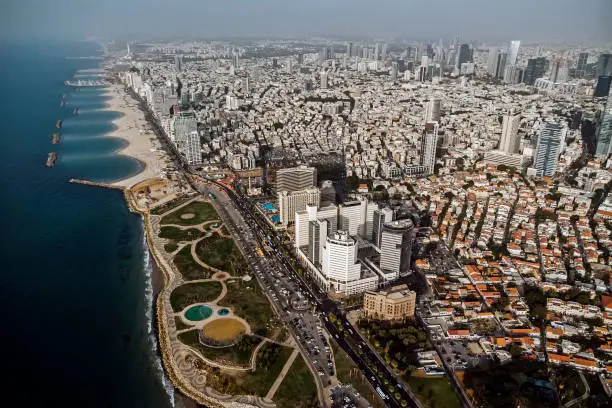 view from the shore to the modern district of Tel Aviv. Top view of the capital of Israel. Clean beautiful beach in the city center of the metropolis on the background of high skyscrapers.