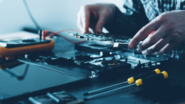 istock electronics repair shop male engineer laptop 1204066460