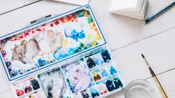 istock artist workplace watercolor palette paintbrush 1204066471