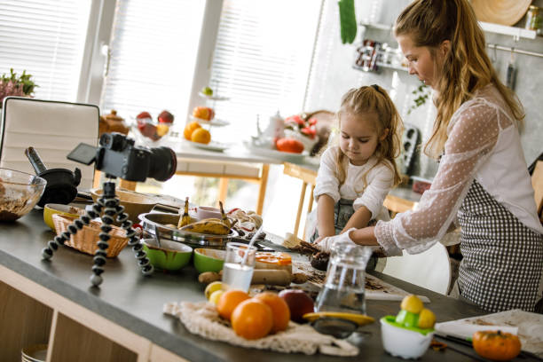 istock Toddler and her mother making a tutorial on how to prepare cookies 1204066524