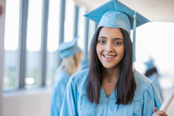 istock Female smiling with pride after receiving diploma from university 1204066572