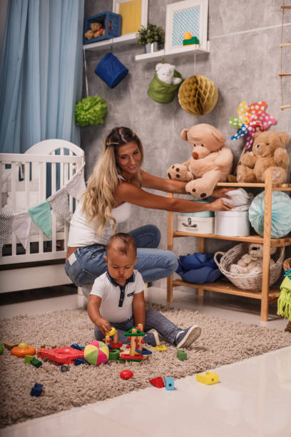 istock Mom folding the clothes while baby plays 1204066575