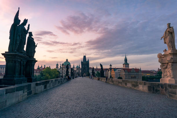 istock Charles Bridge with stone statues at sunrise 1204067761