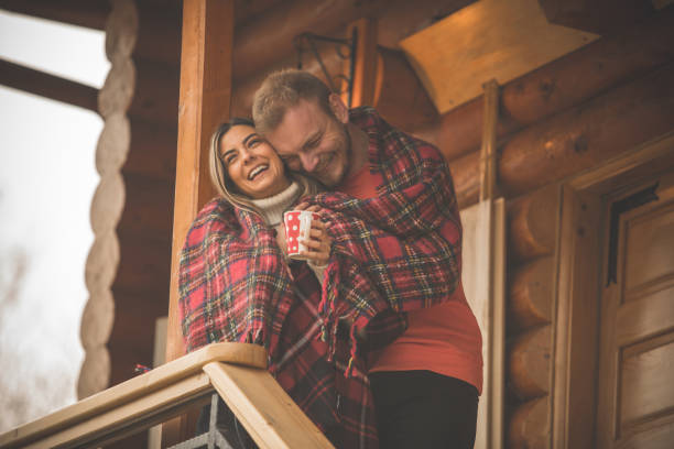 istock Couple cuddling and enjoying their romantic time outdoors on a patio 1204067895