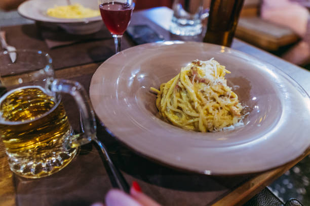istock Carbonara paste. A man eats an Italian dish of pasta carbonara 1204069386
