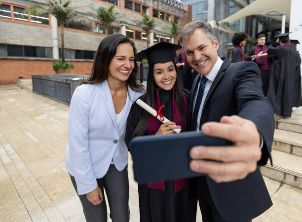istock Happy graduating student taking a selfie with her parents 1204069926