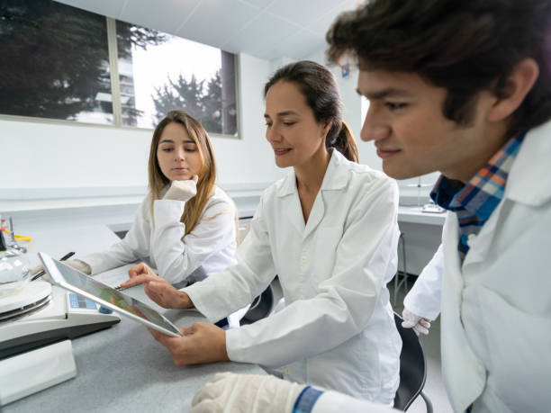 istock Teacher talking to chemistry students at the lab 1204070469