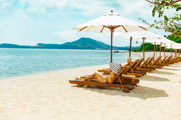 istock Woman in beach chair 1204070616