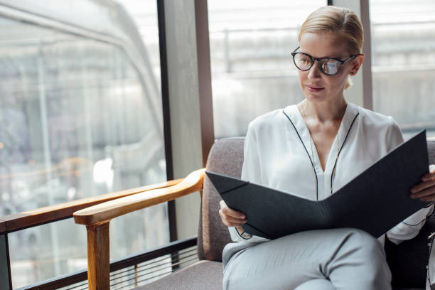 istock Businesswoman reading a File 1204070954