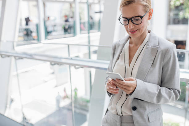 istock Businesswoman Using Her Smart Phone Outdoors 1204071013