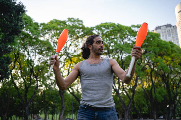istock Handsome Hispanic juggler at a park 1204071080