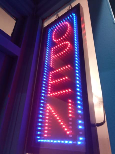 istock Bright electric sign Open at seaside shop 1204071898