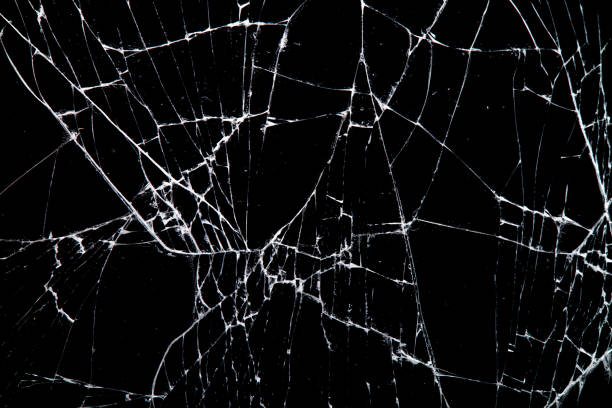 istock cracked glass isolated on a black background. 1204072910