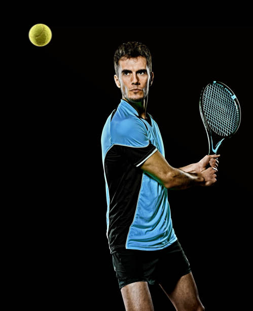 istock caucasian young tennis player man isolated black background 1204073354