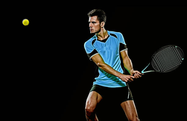 istock caucasian young tennis player man isolated black background 1204073434