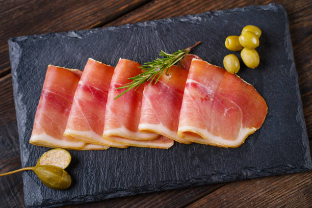 istock Prosciutto served on board with olives 1204073510