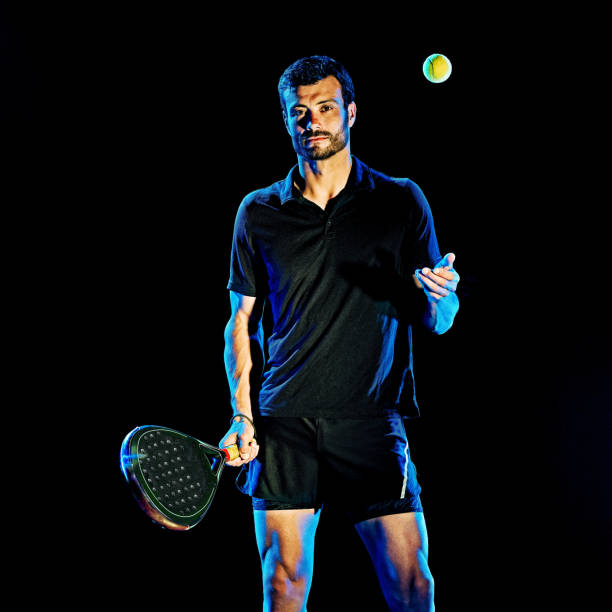 istock Paddle tennis player man light painting isolated black background 1204074590