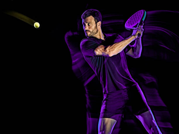istock Paddle tennis player man light painting isolated black background 1204074616