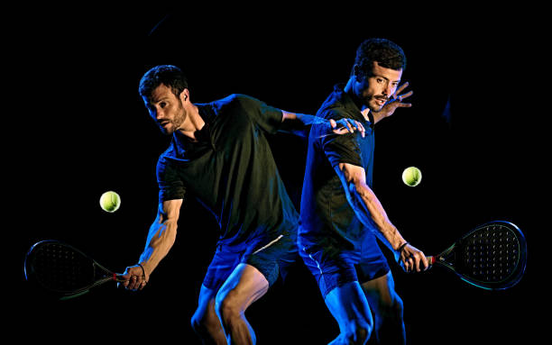 istock Paddle tennis player man light painting isolated black background 1204074642