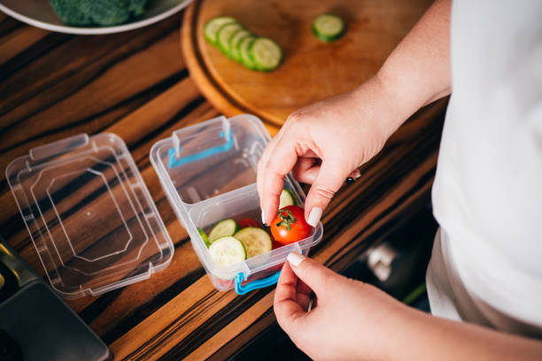 istock Woman serving lunch in plastic box.Take away food. 1204077222