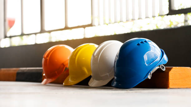 Safety Construction Worker Hats Blue, white, yellow, orange. Teamwork of construction team must have quality. Whether it engineer, construction workers. Have a helmet to wear at work. Safety at work. stock photo