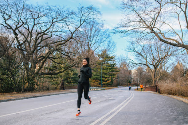 istock Young woman running in NYC Central park 1204082773