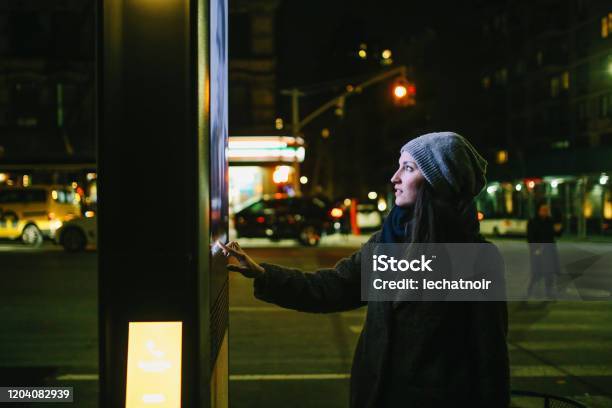 Woman Using Touch Screen City Display Stock Photo - Download Image Now - Billboard, Digital Display, Technology