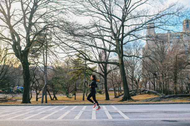 istock Young woman running in NYC Central park 1204083114