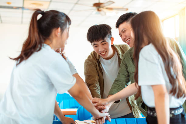 istock collage Student  Putting their Hands on Top of One Another 1204083232