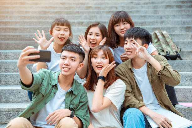 istock Group of students taking selfie on the stairs  at campus 1204084073